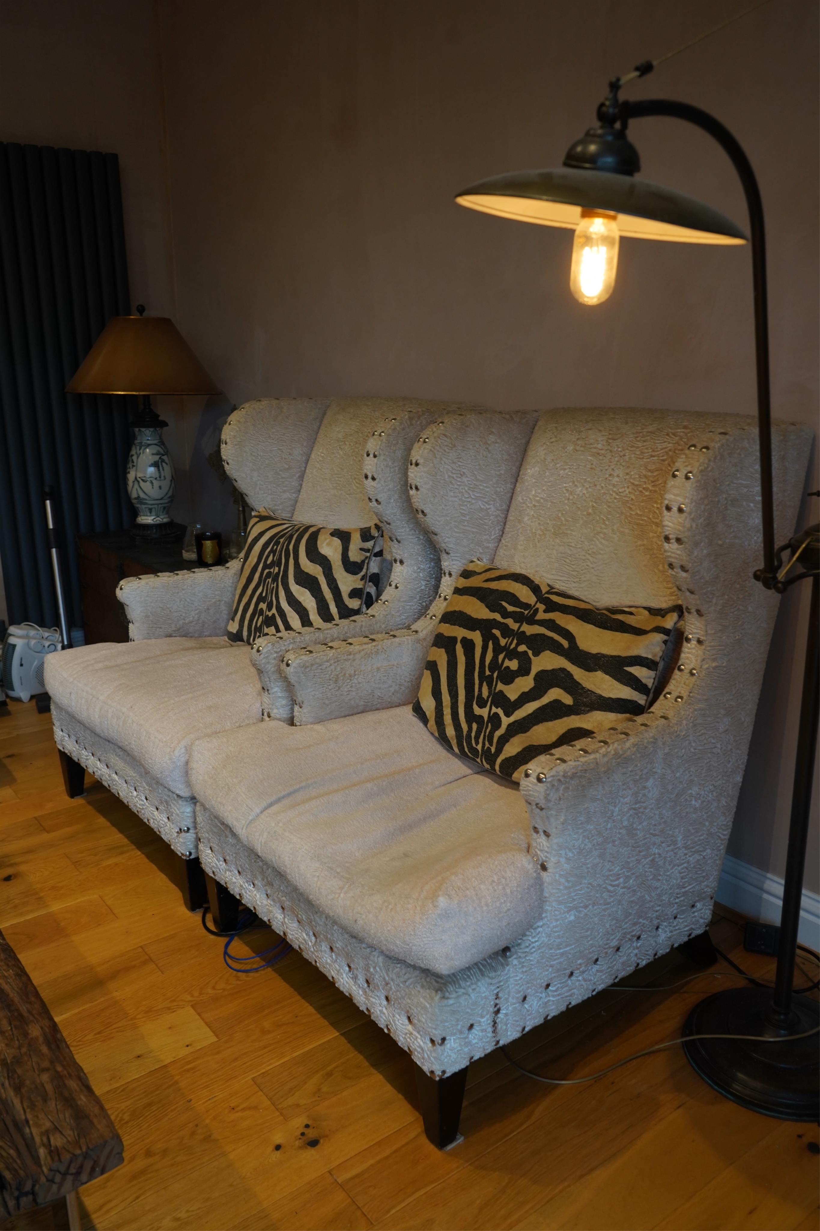 A pair of Martin Fleming armchairs with zebra cushions, width 85cm, depth 80cm, height 112cm. Condition - fair